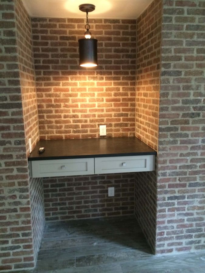 Built-in desk fitted into a brick nook